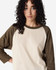 A unisex raglan T-shirt featuring a beige body and brown sleeves, with a model displaying the shirt.