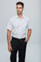 A short-sleeve button-up shirt in white, modelled by a man wearing black trousers. It features a pocket and a logo.