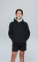 A child wearing a black hoodie with blue accents, standing against a plain background. The hoodie features a logo.
