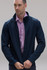 A navy soft shell jacket worn by a man, featuring a zippered front and a collar. It has a logo on it.