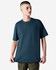 A model wearing a dark teal oversized T-shirt with short sleeves. The shirt has a simple design and a logo.
