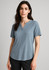 A short-sleeve blouse in a soft blue hue with a relaxed fit and a v-neckline. Features a logo on the garment.