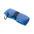 A blue travel towel is neatly rolled and secured with a black strap, featuring a carabiner for attachment.
