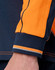 A close-up of a navy and orange long-sleeve polo featuring contrasting stripes at the cuffs. The image includes branding.