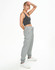 A model wears grey unisex airlayered CVC sweatpants paired with a black crop top and white sneakers.