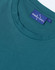A close-up of a teal men's premium cotton t-shirt featuring a crew neckline and a branded label.