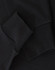 A close-up of black long-sleeve cotton tee shirt cuffs, featuring a visible logo.