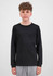 A youth long sleeve tee in black, featuring a simple design and long sleeves. The model stands against a plain background.