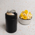 A drink bottle in black stainless steel beside a bowl of popcorn topped with yellow snacks. The image includes branding.