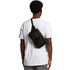 A man wearing a white t-shirt displays a black recycled double waist bag on his back, featuring a logo.