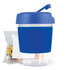 A reusable coffee cup with a blue silicone sleeve and matching lid, accompanied by a package of colorful jelly beans.