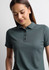 A women's short sleeve polo shirt in dark green, featuring a collared neckline and button placket. It has a logo.