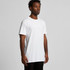 A man wears a plain white t-shirt with short sleeves, featuring a logo. The tee is designed for a relaxed fit.