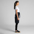 A half apron in dark grey, featuring a waist tie, paired with a white T-shirt and black pants.
