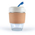 A reusable coffee cup in transparent glass with a cork band and a light-colored lid featuring a blue straw.