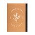 A brown A5 notebook with a black spine and a logo featuring a leaf and berries on the cover.