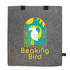 A grey felt tote bag with a colourful graphic featuring a bird, plants, and sun. It has two black handles.