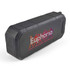 A black, water-resistant speaker with a textured surface and a prominent logo on the front.