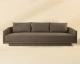 Gannon curved fabric sofa upholstered in Ernst Sandstone with a modern silhouette and fully upholstered base by Be Bold Furniture.