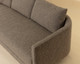 Gannon curved fabric sofa upholstered in Ernst Sandstone with a modern silhouette and fully upholstered base by Be Bold Furniture.