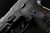 Sig Sauer P320 AXG Magazine Release Kit shown mounted on a handgun black