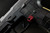 Sig Sauer P320 AXG Magazine Release Kit shown mounted on a handgun in red