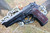 Beretta 92 "VERITAS AEQUITAS" shown in Black/Red on a gun