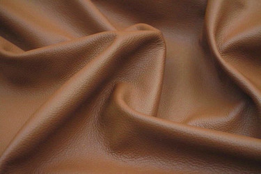 Close-up picture of Caramel soft rich brown leather for upholstery with natural grain texture