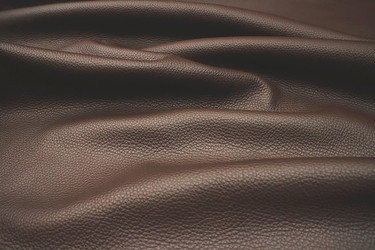 Close-up picture of Maui, coffee brown full grain leather for upholstery with pebble grain texture