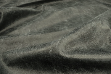 Close up picture of cool grey/black pull up upholstery leather