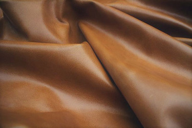 Close-up picture of Restoration Gold soft, Italian leather for upholstery with smooth grain texture