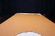 Picture of Audubon Gold, real golen leather hide for upholstery displayed on a table.