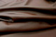 Close-up picture of Chocolate Cherry Splash, brown leather fabric for seats, sofas and other furniture upholstery 
