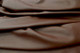 Picture of draping Chocolate Cherry Splash, brown leather skins for upholstery and furniture.