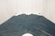 Picture of sapphire metallic blue distressed leather displayed on a table