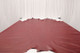 Picture showing warm deep red natural pebble grain upholstery leather displayed on a table
