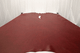 Picture of Ella In Red, deep red semi-aniline leather hide for upholstery displayed on a table
