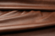 Closeup picture of Whiskey Beat soft, rich warm brown colored upholstery leather for furniture