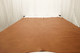 Picture of Hangin in Harlem, warm brown semi-aniline leather hide for upholstery displayed on a table