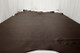 Picture of Rich Tobacco, rich brown colored leather hide for upholstery displayed on a table