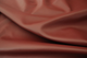 Close up picture of warm deep red Italian upholstery leather