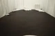 Rich dark brown top grain upholstery leather displayed on a table