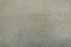 Close up of metallic gold with teal accents embossed suede-like upholstery leather