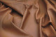 Close-up picture of Caramel, rich brown leather fabric for seats, sofas and other furniture upholstery 