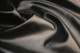 Close-up picture of Restoration Black soft, Italian leather for upholstery with smooth grain texture
