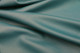 Close-up picture of Teal, rich blue green full grain leather for upholstery with pebble grain texture