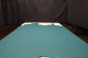 Picture of Teal, rich blue green colored leather hide for upholstery displayed on a table