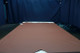 Picture of Maple, saddle brown colored leather hide for upholstery displayed on a table