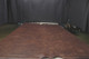 Picture of Chocolate Distress full grain leather hide for upholstery displayed on a table