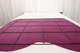 Fuchsia pink leather suede displayed on a table with a sizing grid
